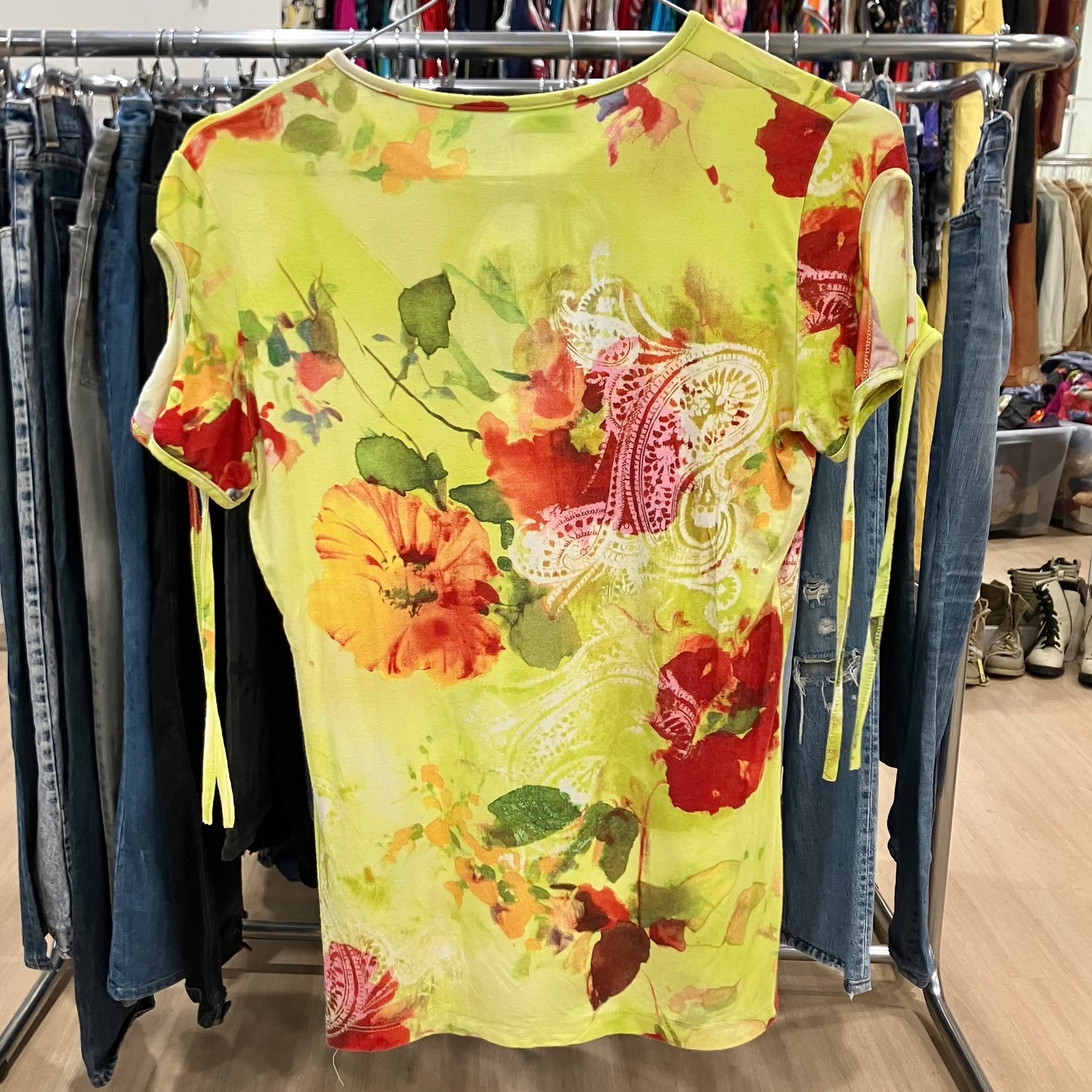 Colorful floral dress hanging on a rack in a store