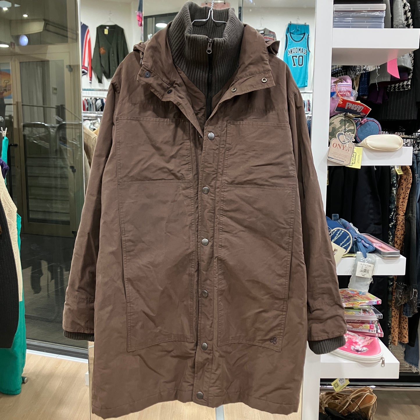 Brown coat on a hanger in a store setting