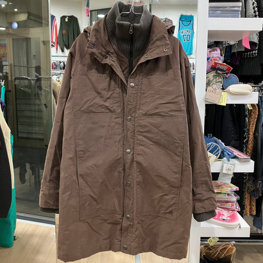 Brown coat on a hanger in a store setting