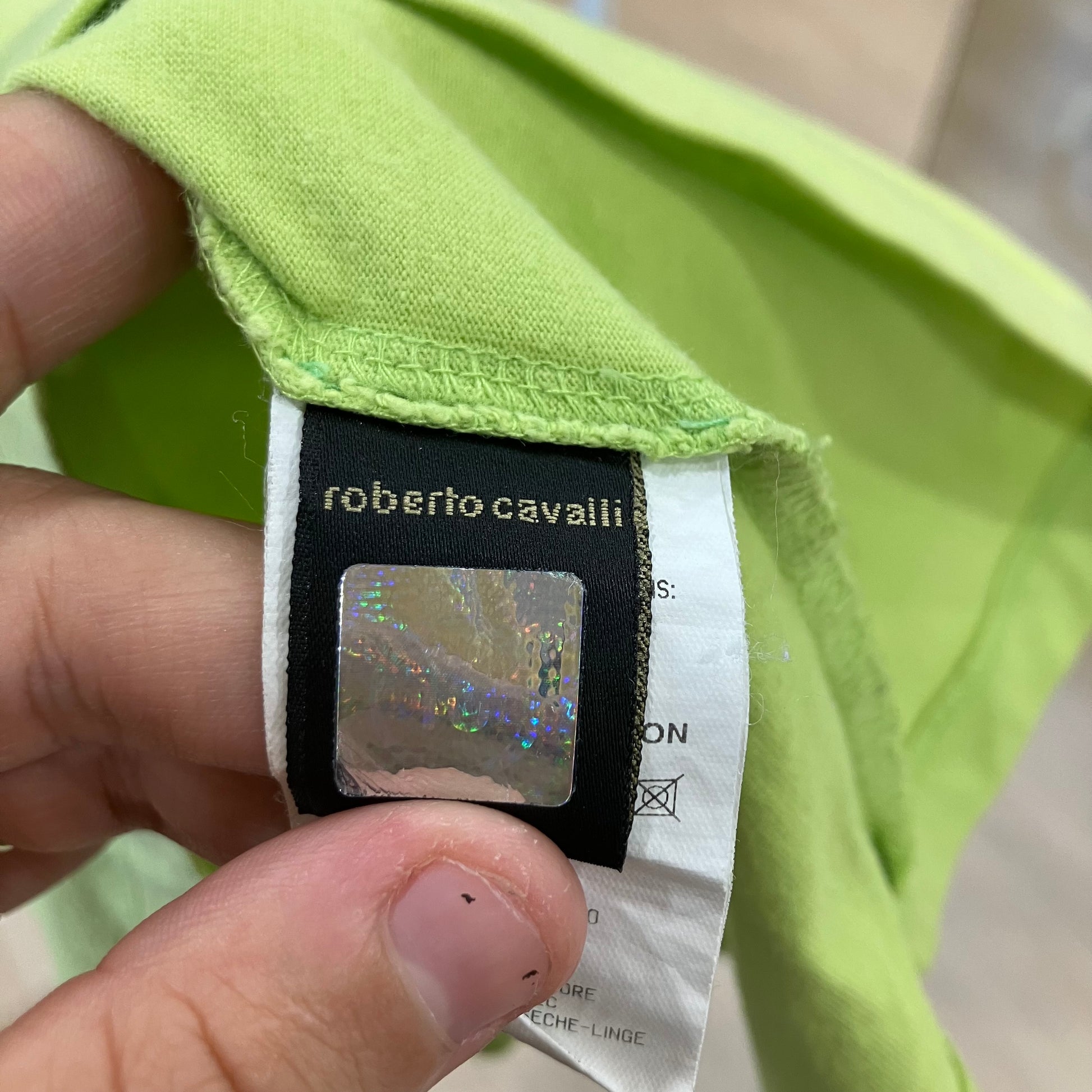 Close-up of a Roberto Cavalli label on a green garment