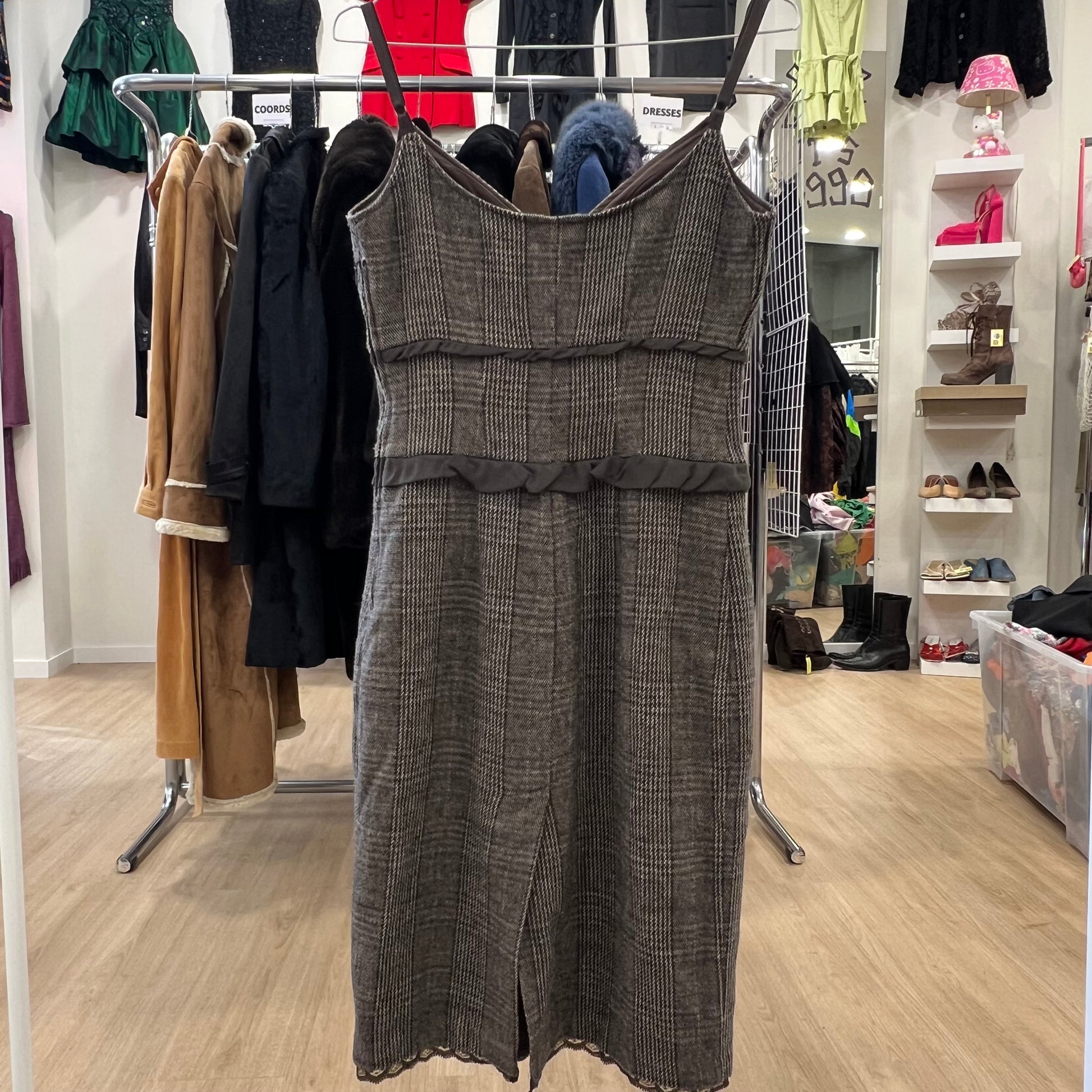 Plaid dress hanging on a rack in a store setting