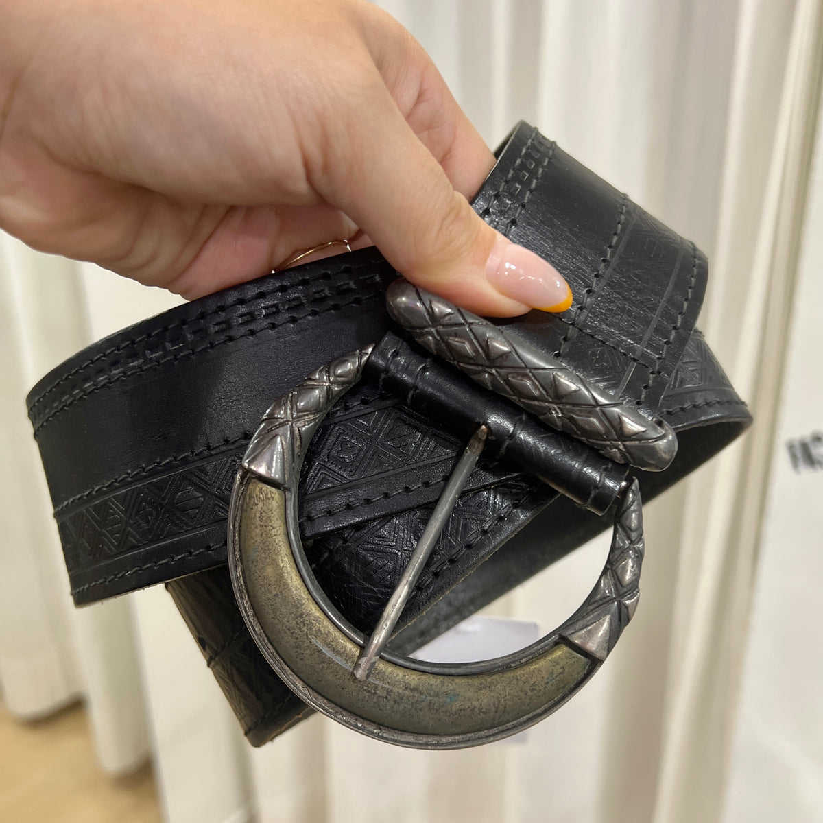 black leather belt embossed with geometric print