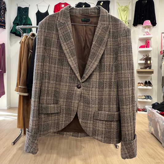 Plaid blazer on a hanger in a clothing store setting