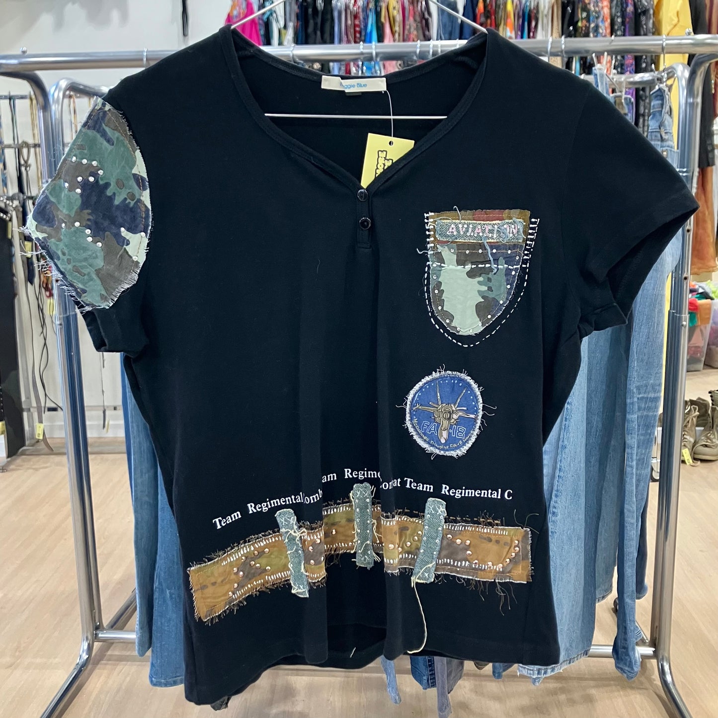 Black upcycled t-shirt with camouflage patches and military-inspired embroidery detail