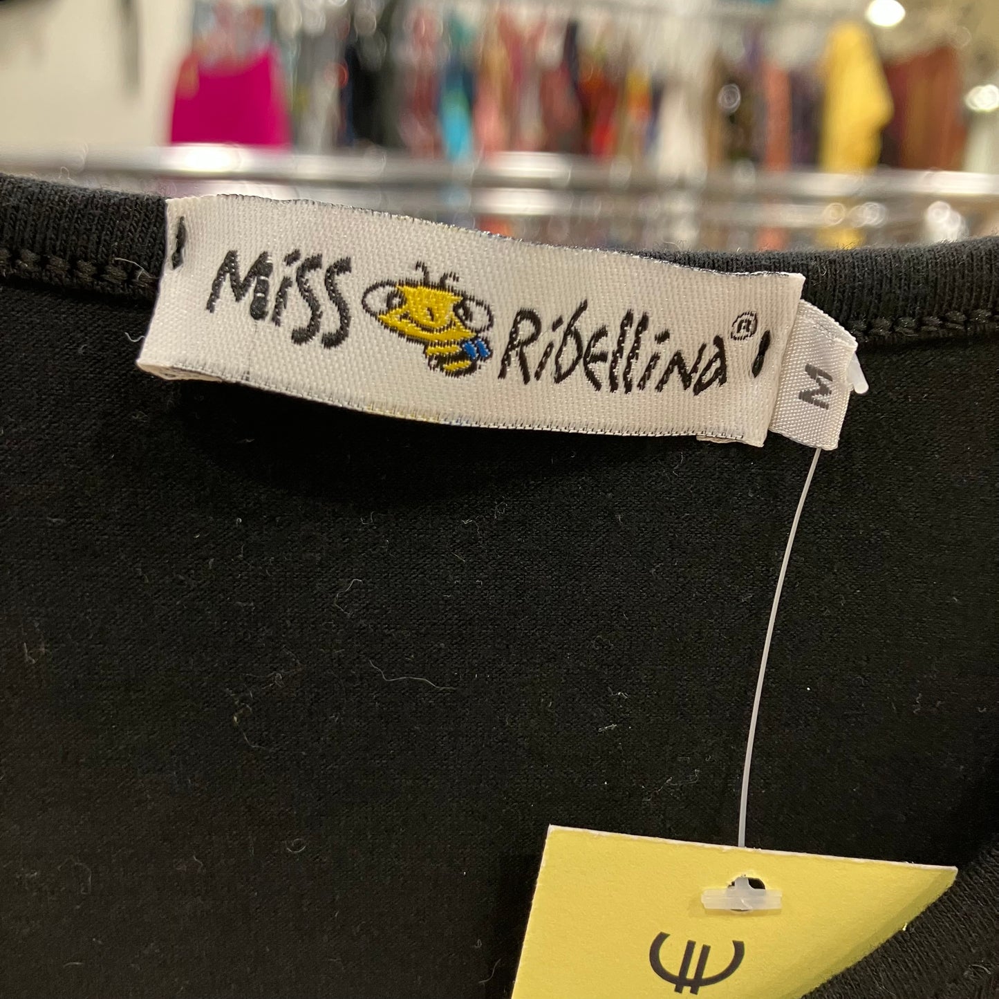 Label with 'Miss Ribellina' branding on a black garment