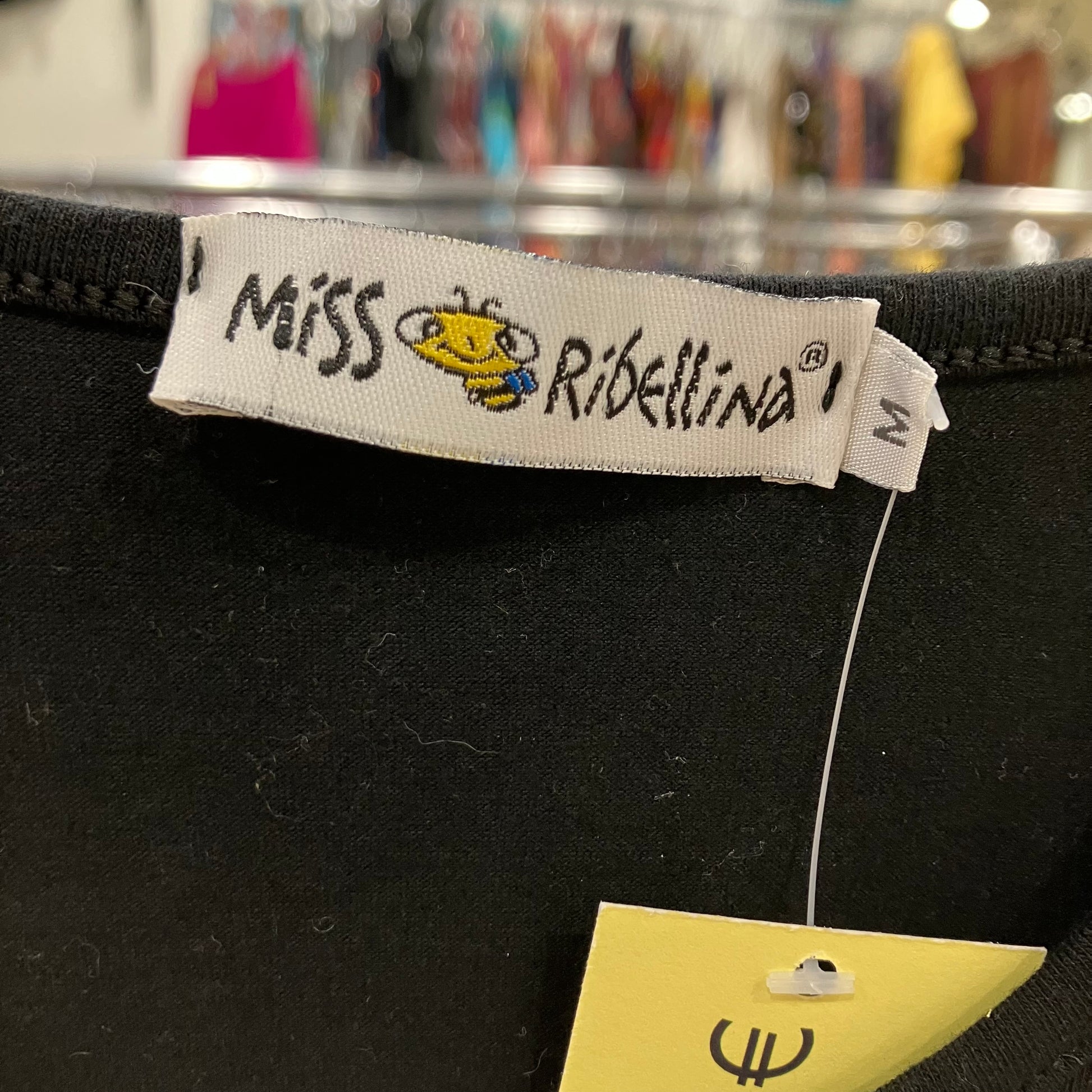 Label with 'Miss Ribellina' branding on a black garment