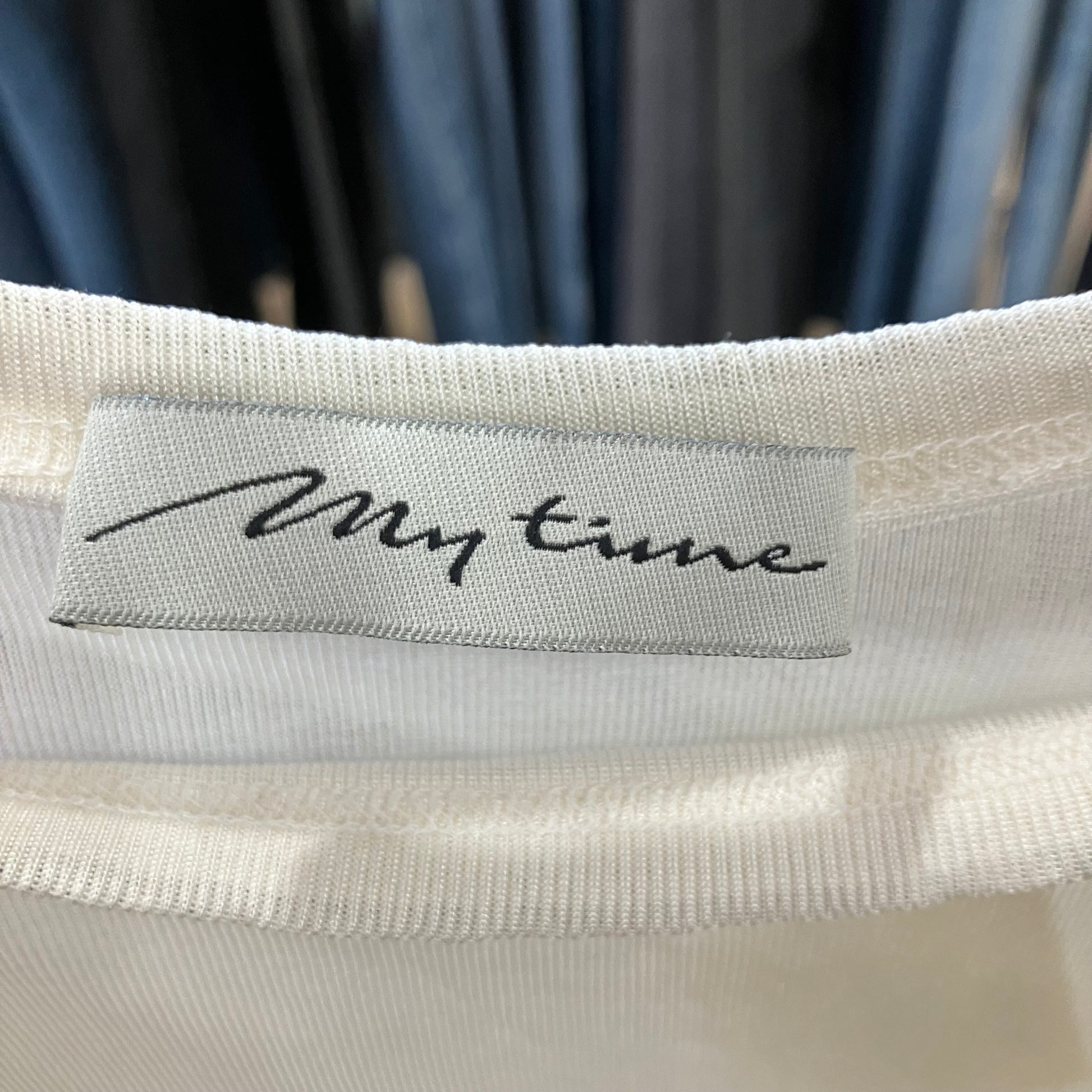 Close-up of a label on a garment with 'My time' text