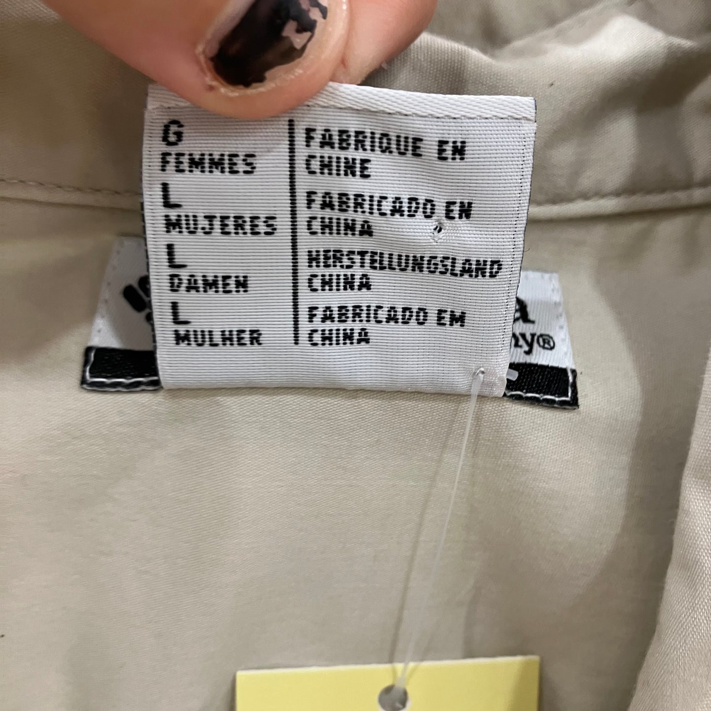 Fabrication label on a beige garment with text in multiple languages