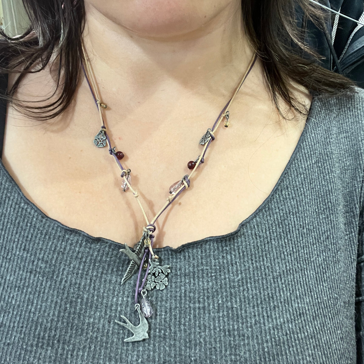 boho whimsy string necklace with silver floral and swallow pendants