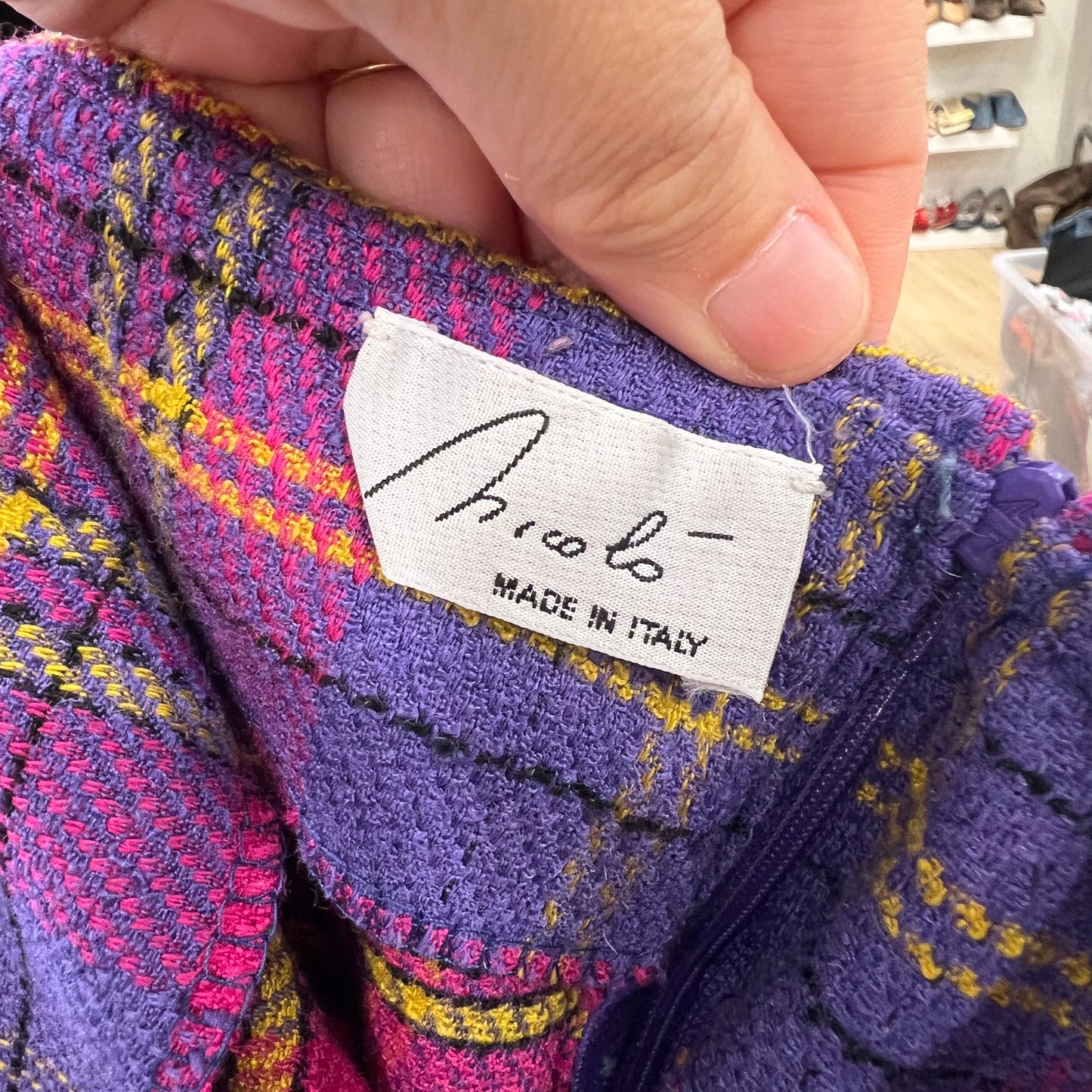 Close-up of a colorful fabric with a 'Nicolo' label indicating 'Made in Italy'