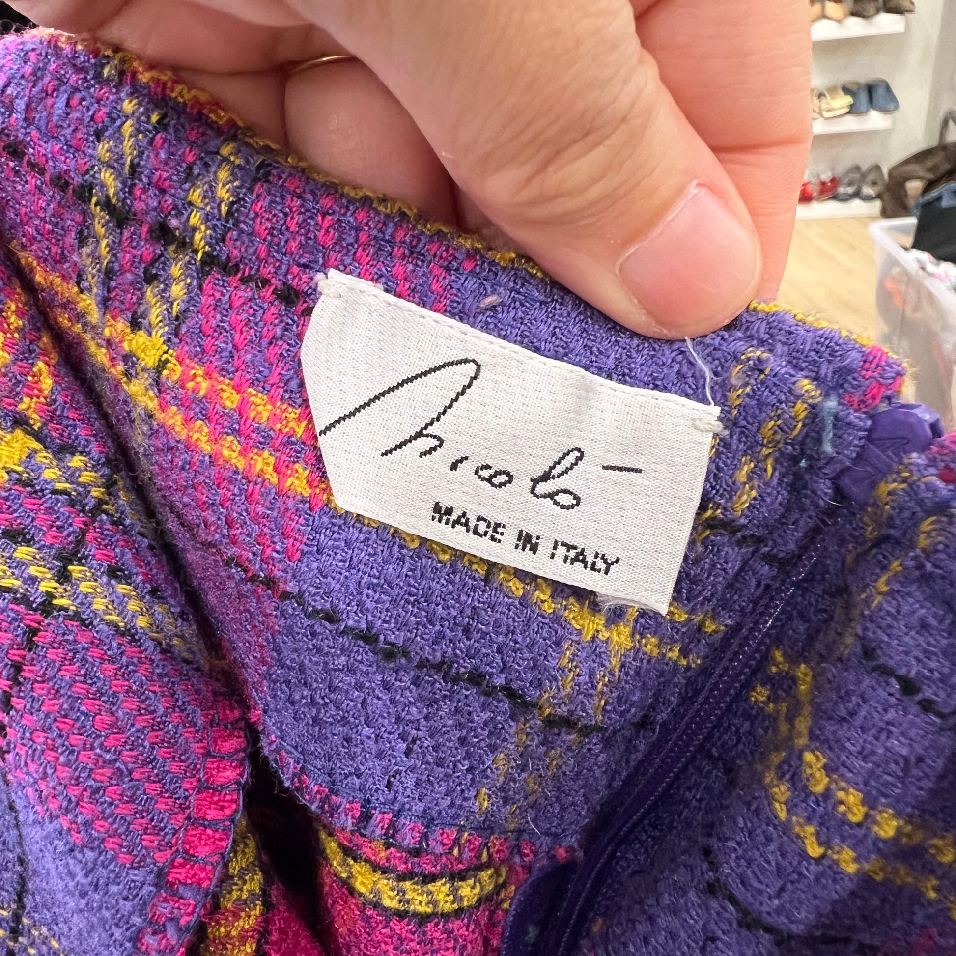 Close-up of a colorful fabric with a 'Nicolo' label indicating 'Made in Italy'