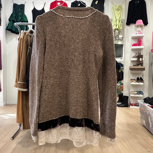 Brown sweater with pearl neckline displayed in a store setting