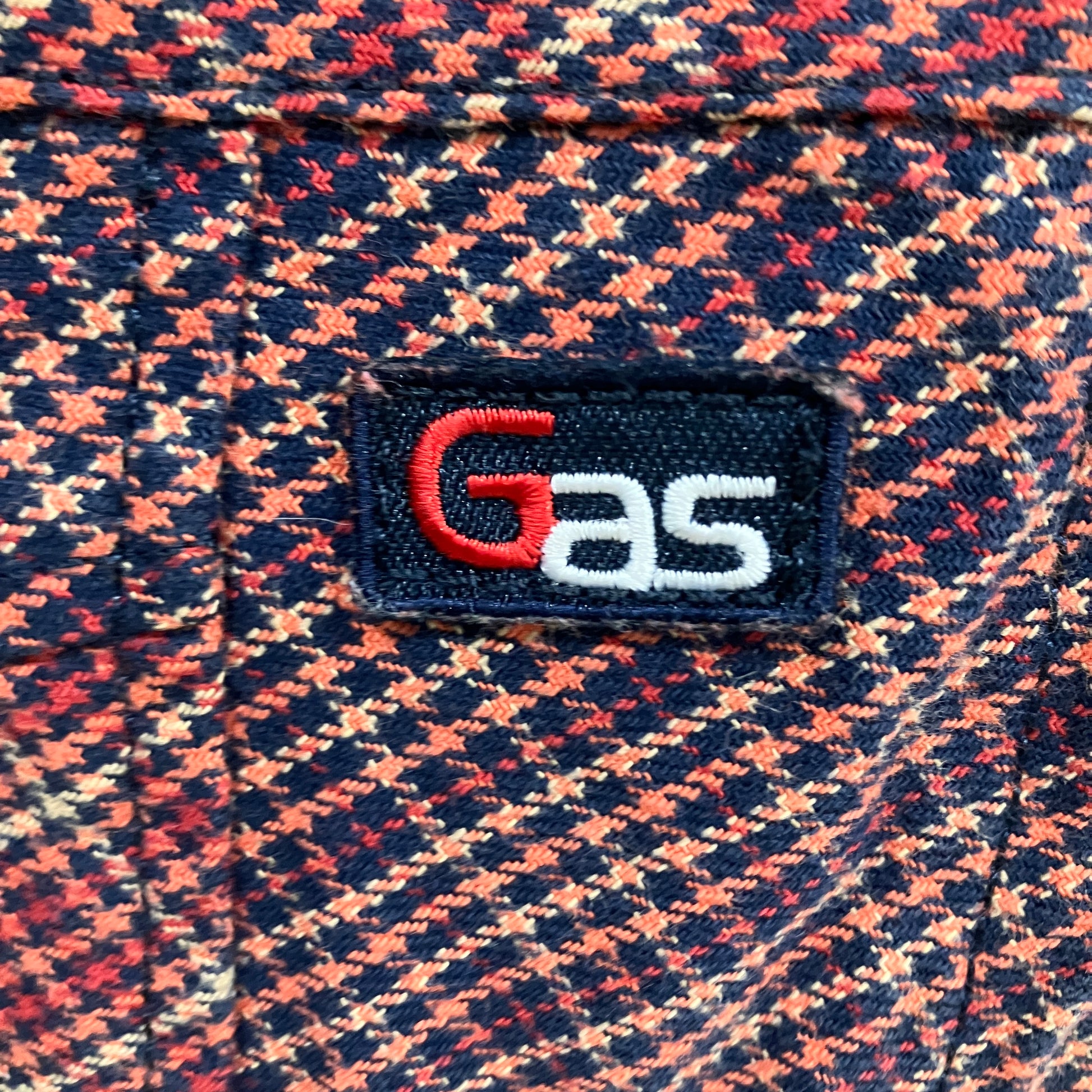 Close-up of a patterned fabric with a 'GAS' logo patch