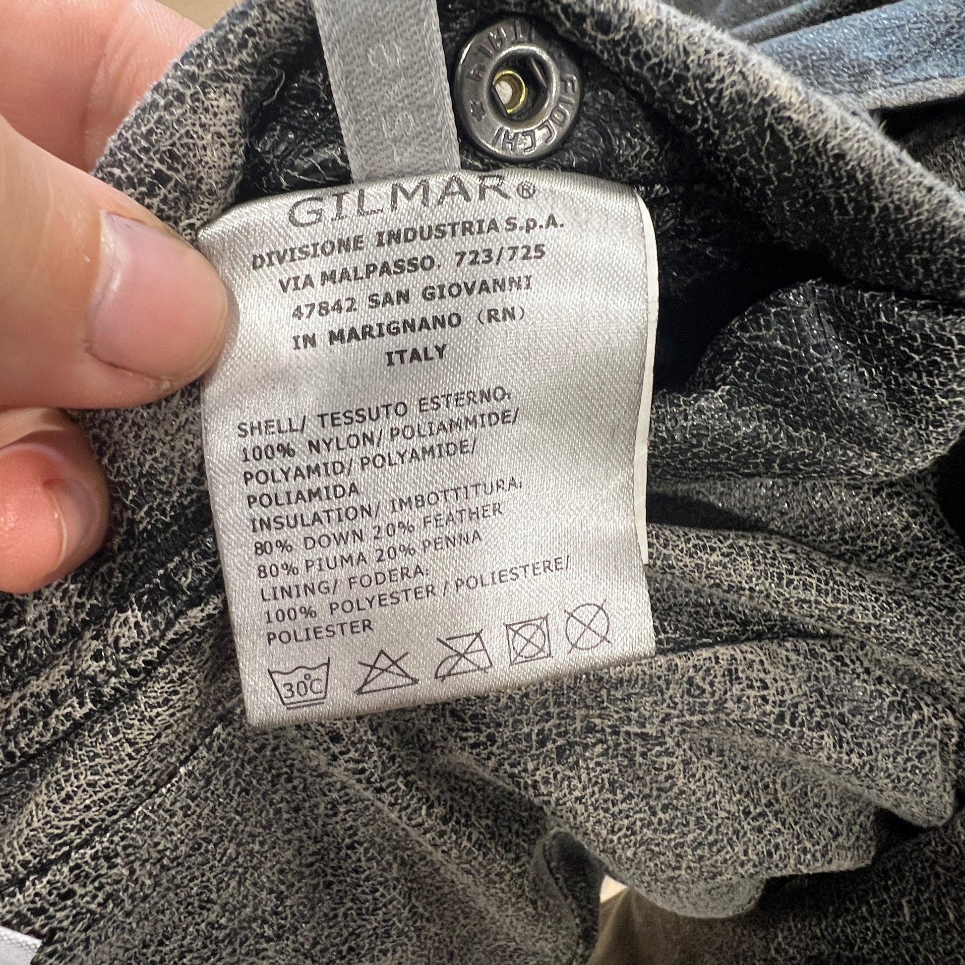 Close-up of a Gilmar label on a textured fabric background