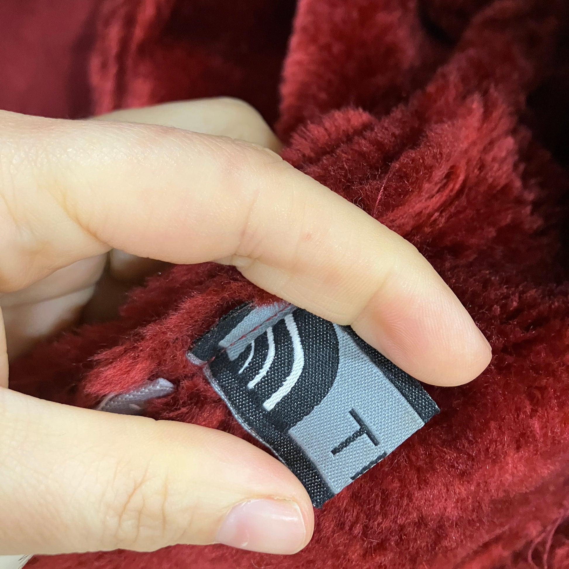 Close-up of a label on a red textured fabric