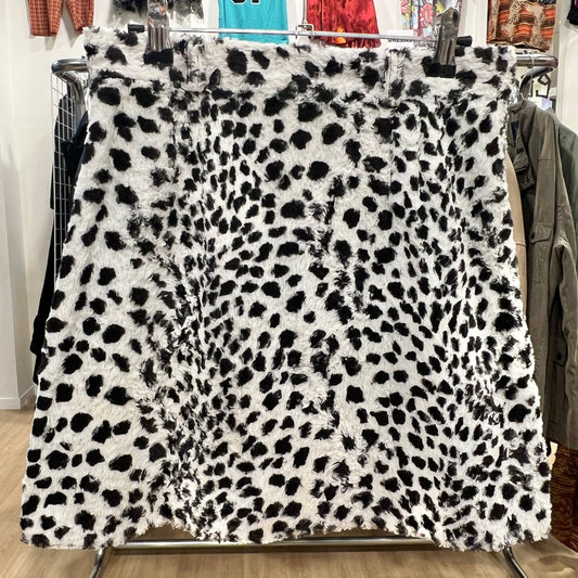 Leopard print fabric on a rack with clothing in the background