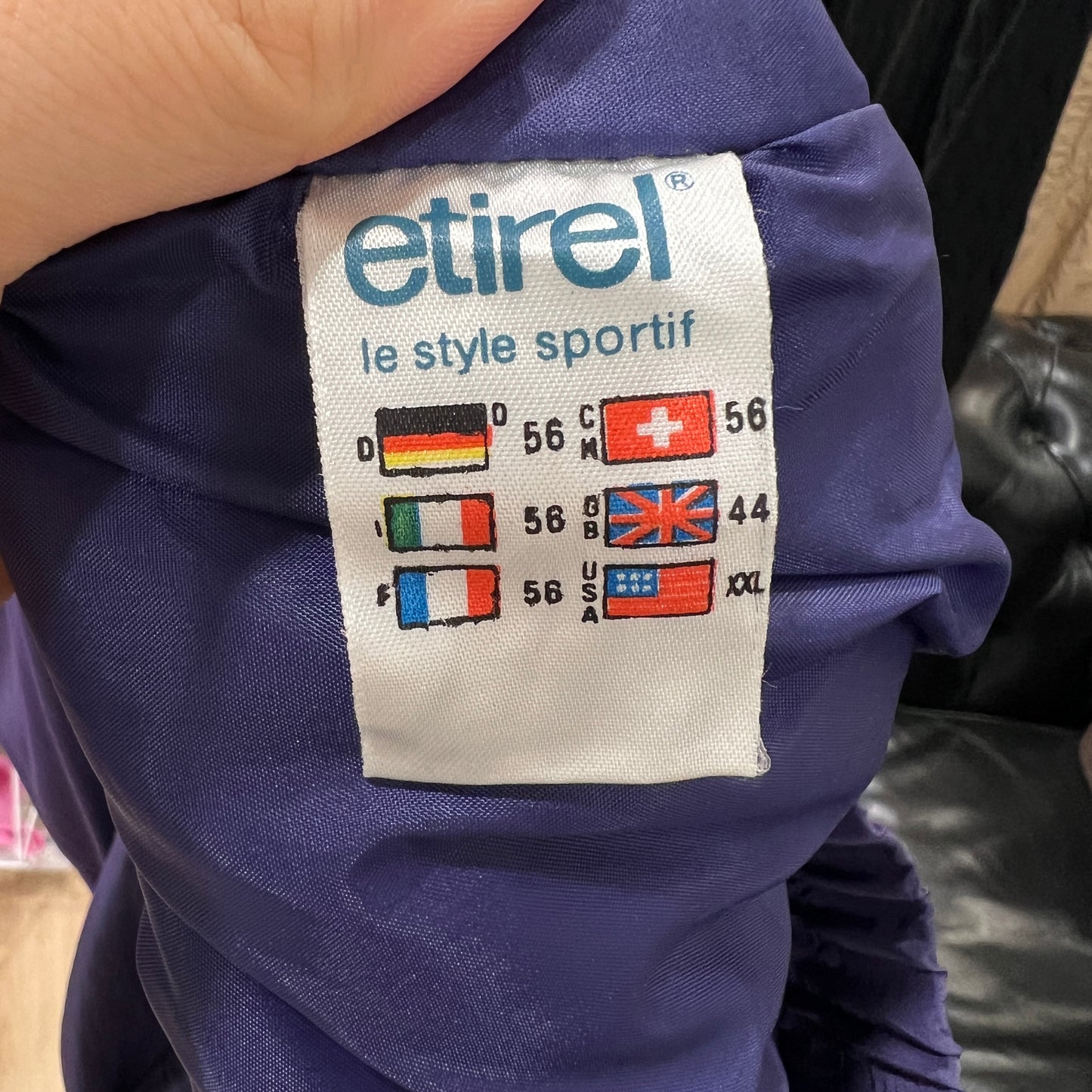 Etirel label on a purple garment with size chart