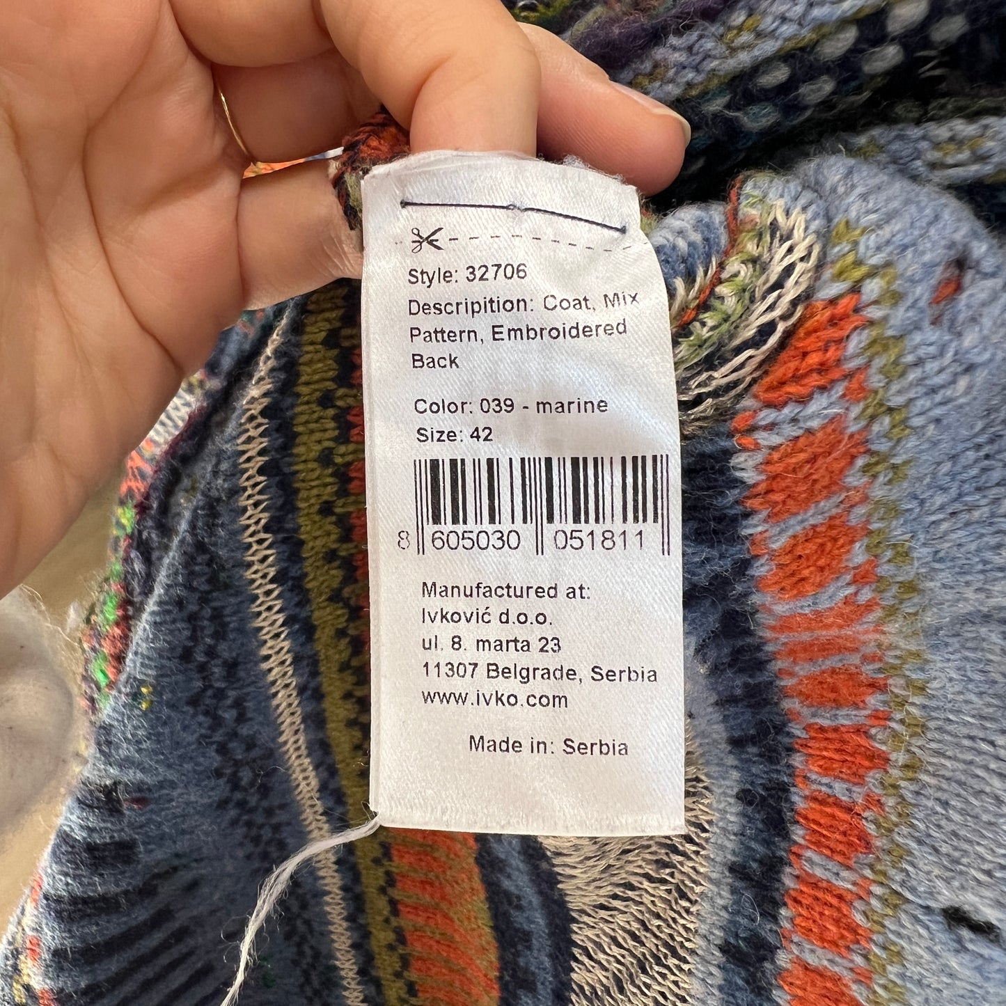 Textile product tag on a patterned fabric background