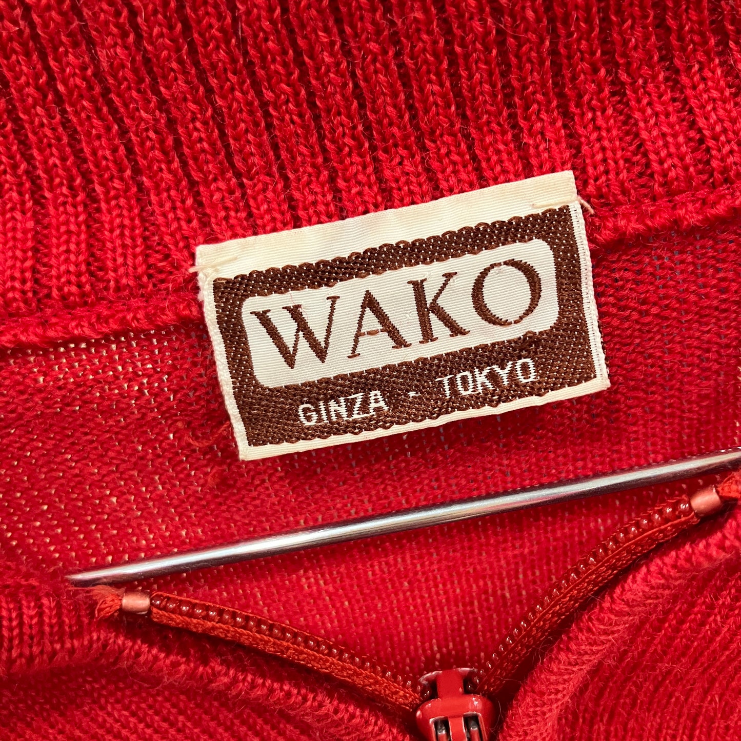 Red fabric with a Wako label on a textured background