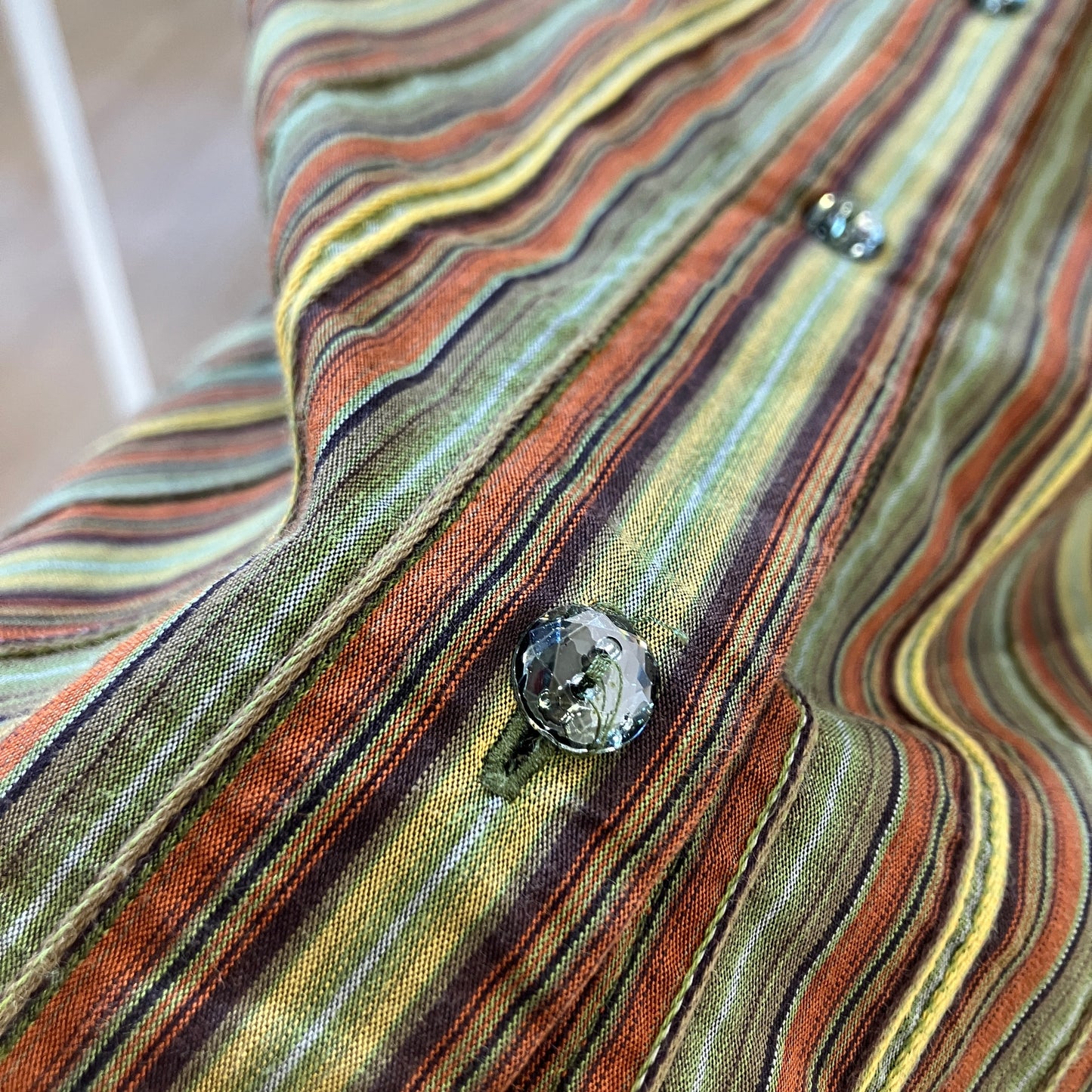 Close-up of a multicolored striped fabric with buttons