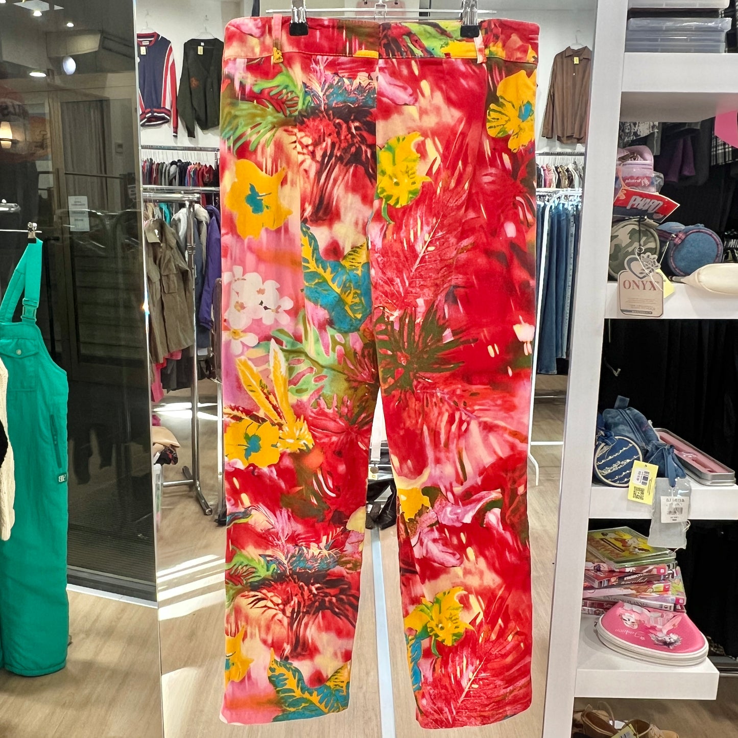 Colorful floral-patterned pants displayed in a store setting