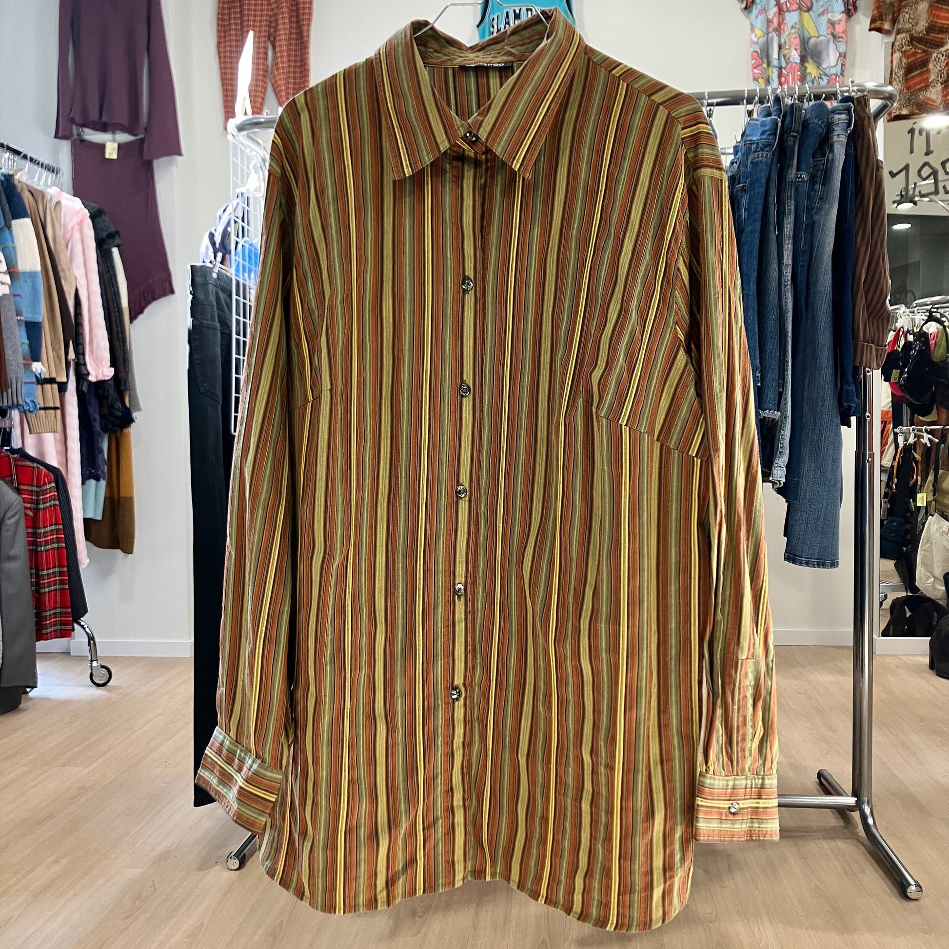 Striped shirt hanging on a rack in a store setting