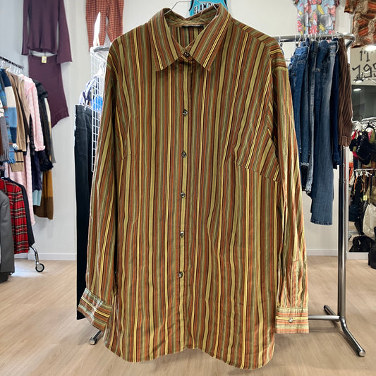 Striped shirt hanging on a rack in a store setting