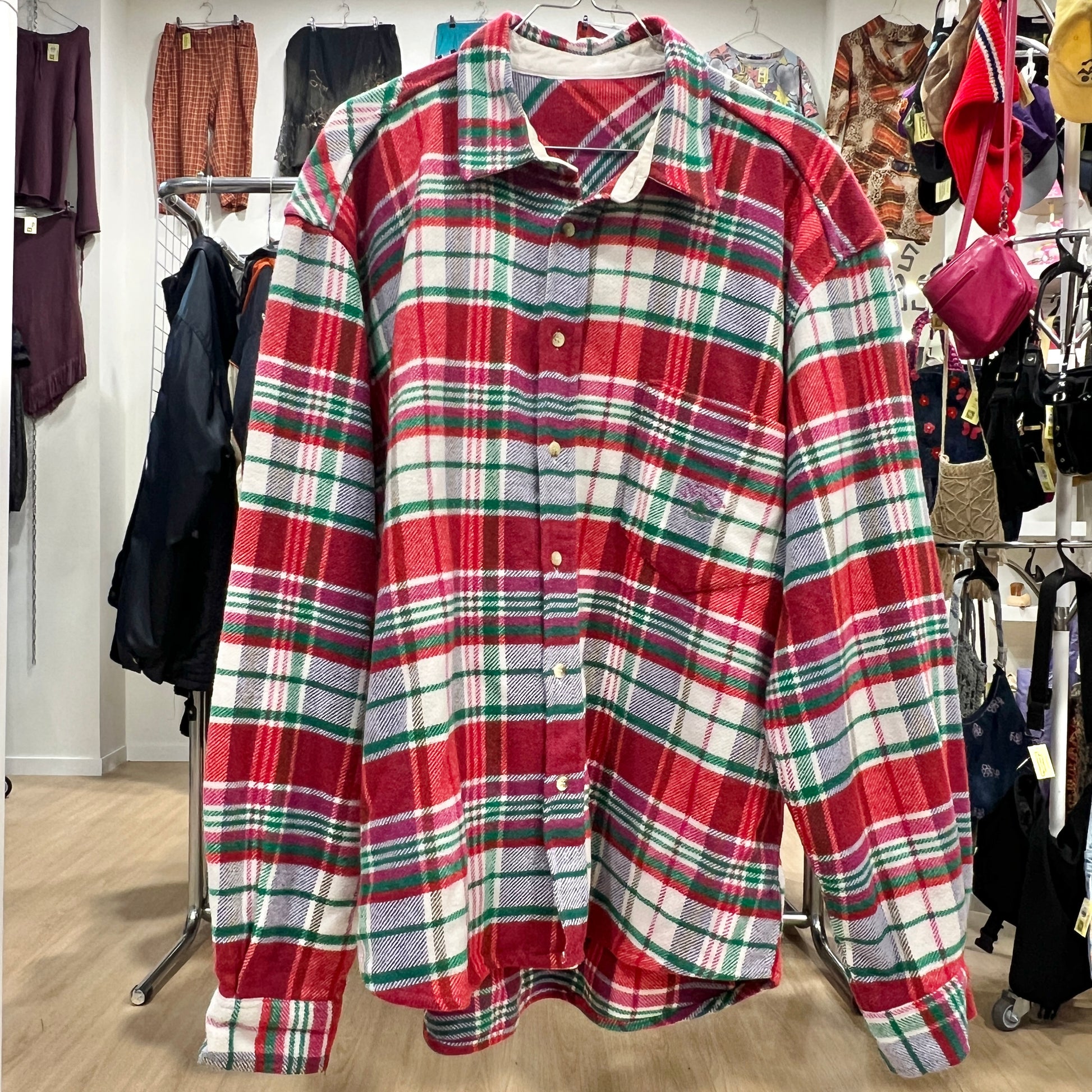 Plaid shirt on a rack with a store setting in the background