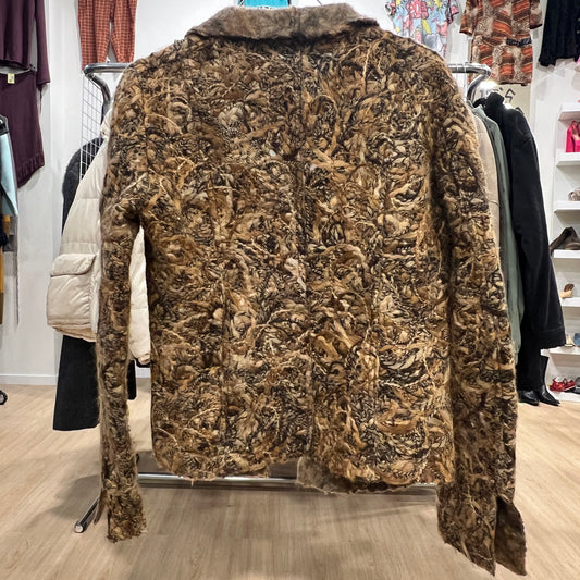 Brown textured jacket on a rack in a store setting