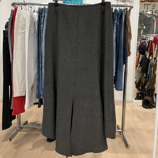 Gray skirt on a clothing rack with other garments in a store setting