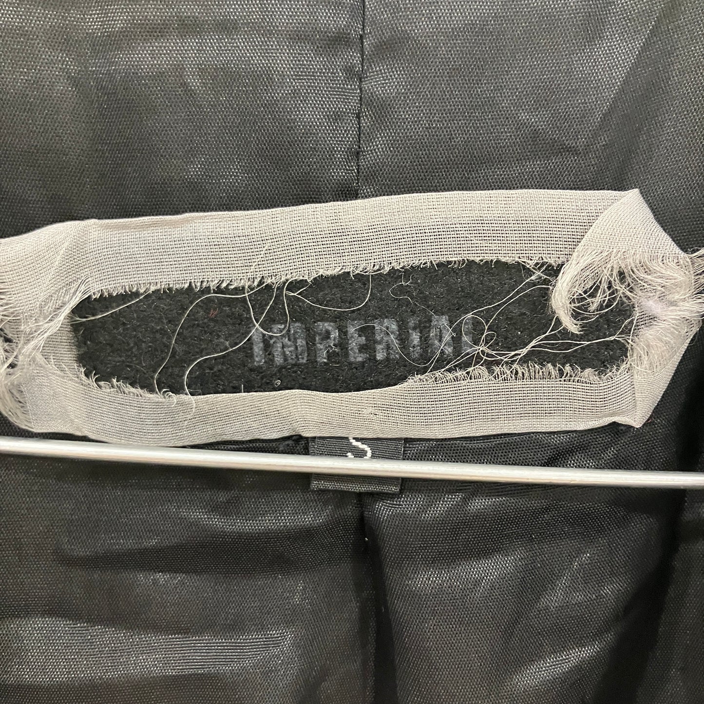 Textile sample with 'Imperial' branding on a black background