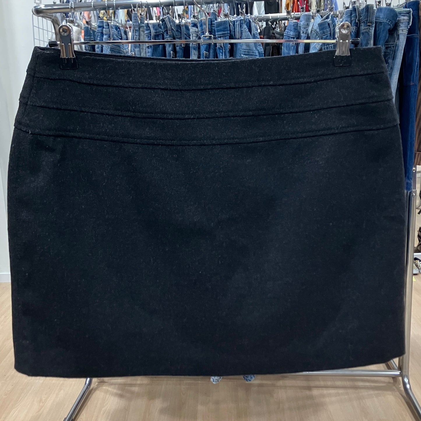 Black skirt on a rack with jeans in the background