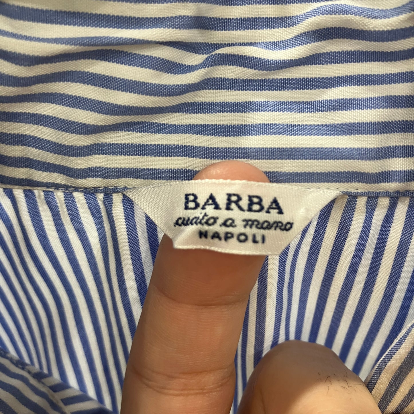 Close-up of a Barba label on blue and white striped fabric