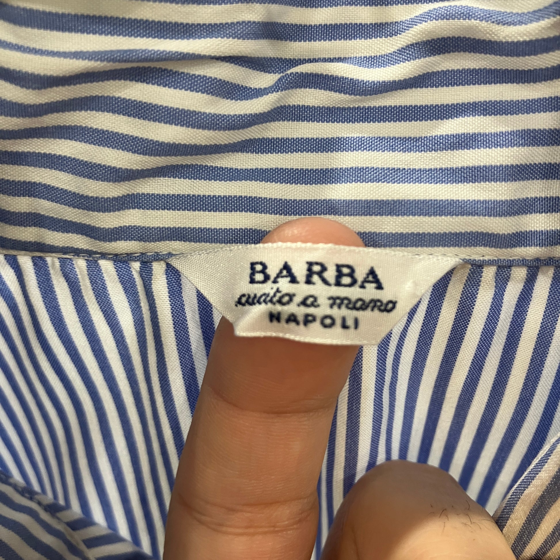 Close-up of a Barba label on blue and white striped fabric