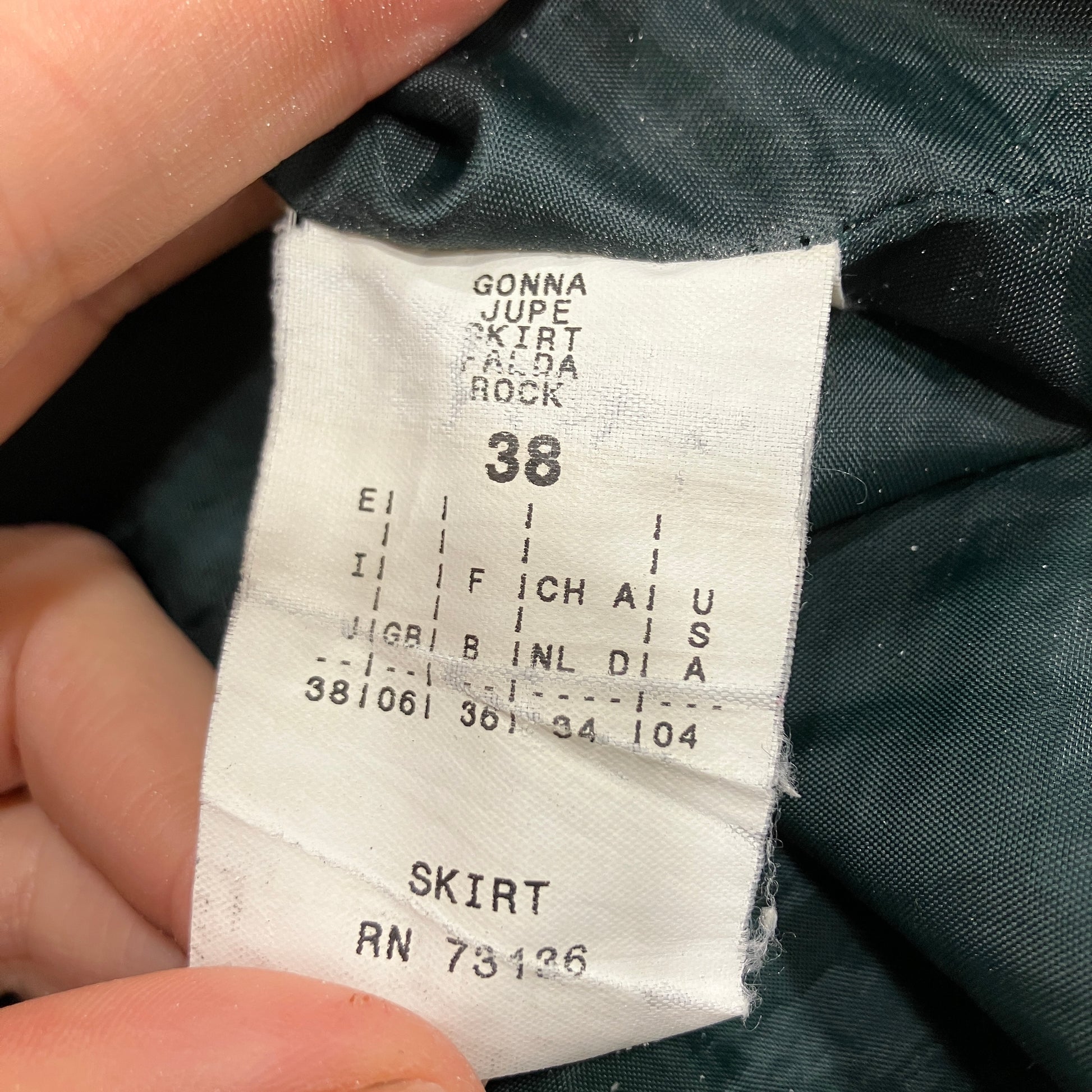 Clothing tag on a skirt with size 38 and brand information