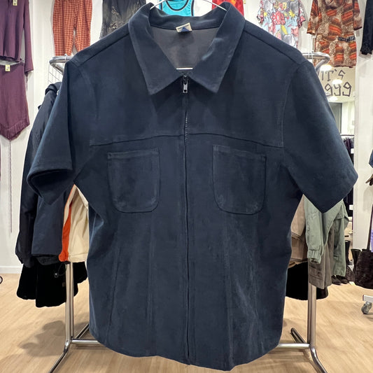 Navy blue jacket on a hanger in a clothing store