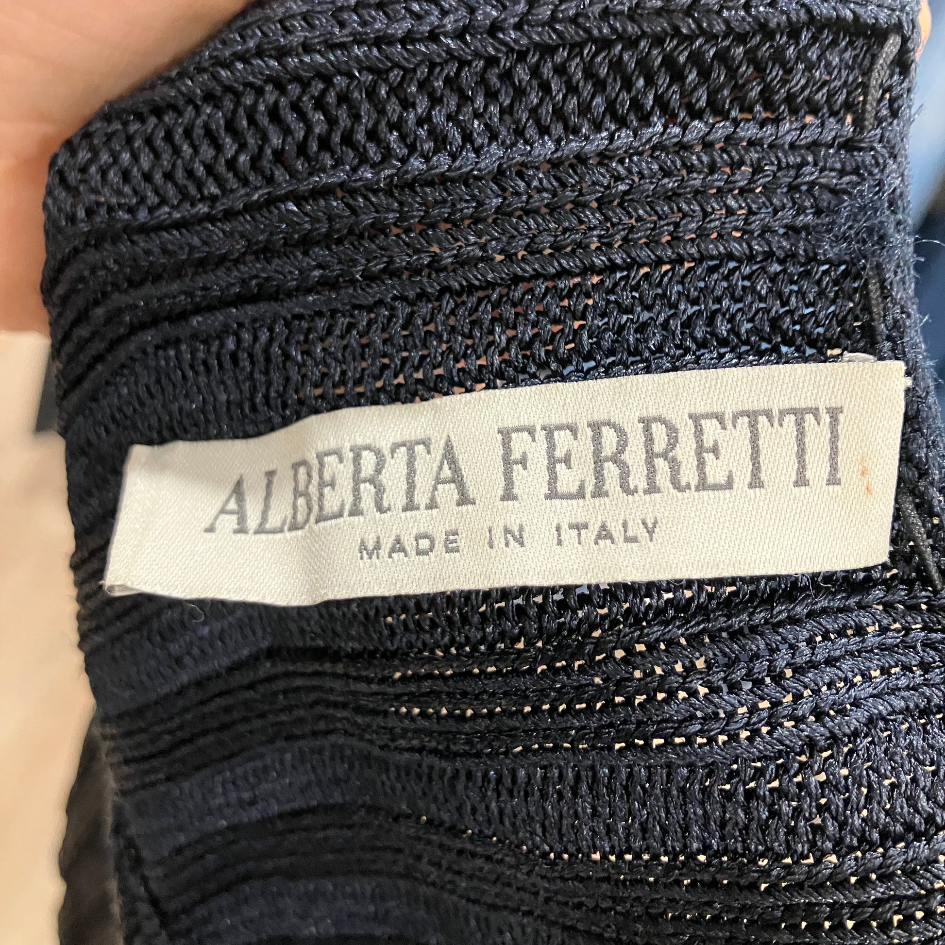 Close-up of Alberta Ferretti label on a textured fabric background
