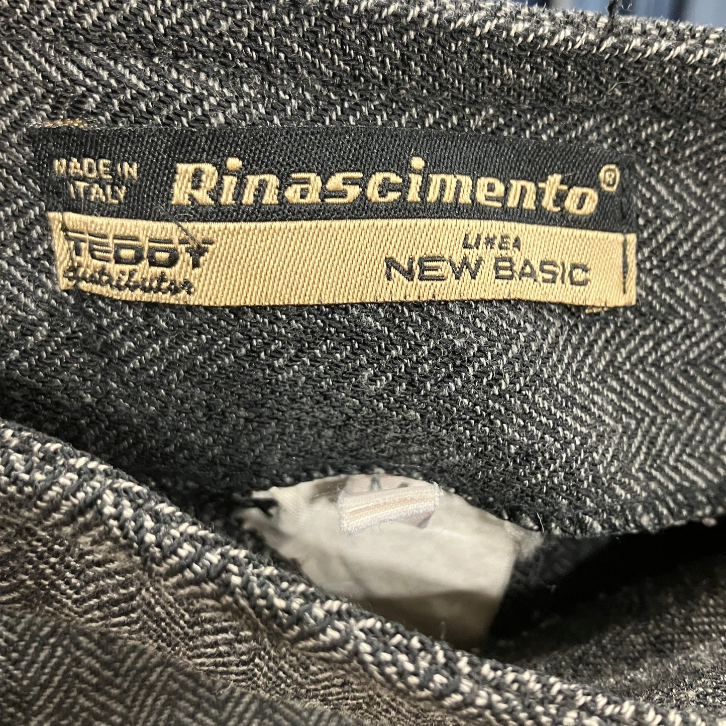 Rinascimento label on a textured fabric background