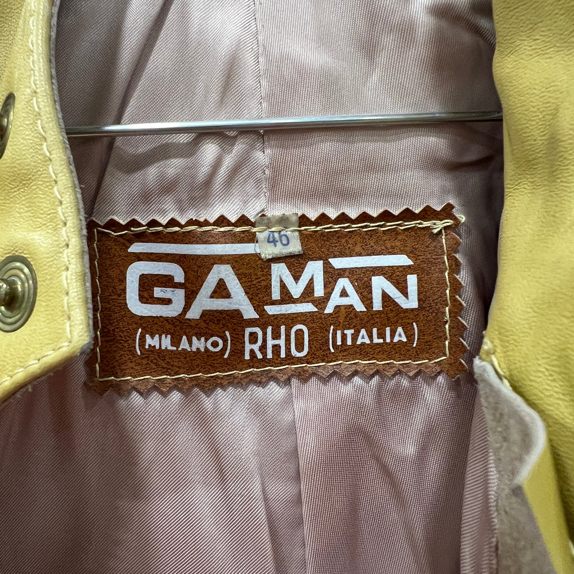 Gaman label on a garment with a beige background