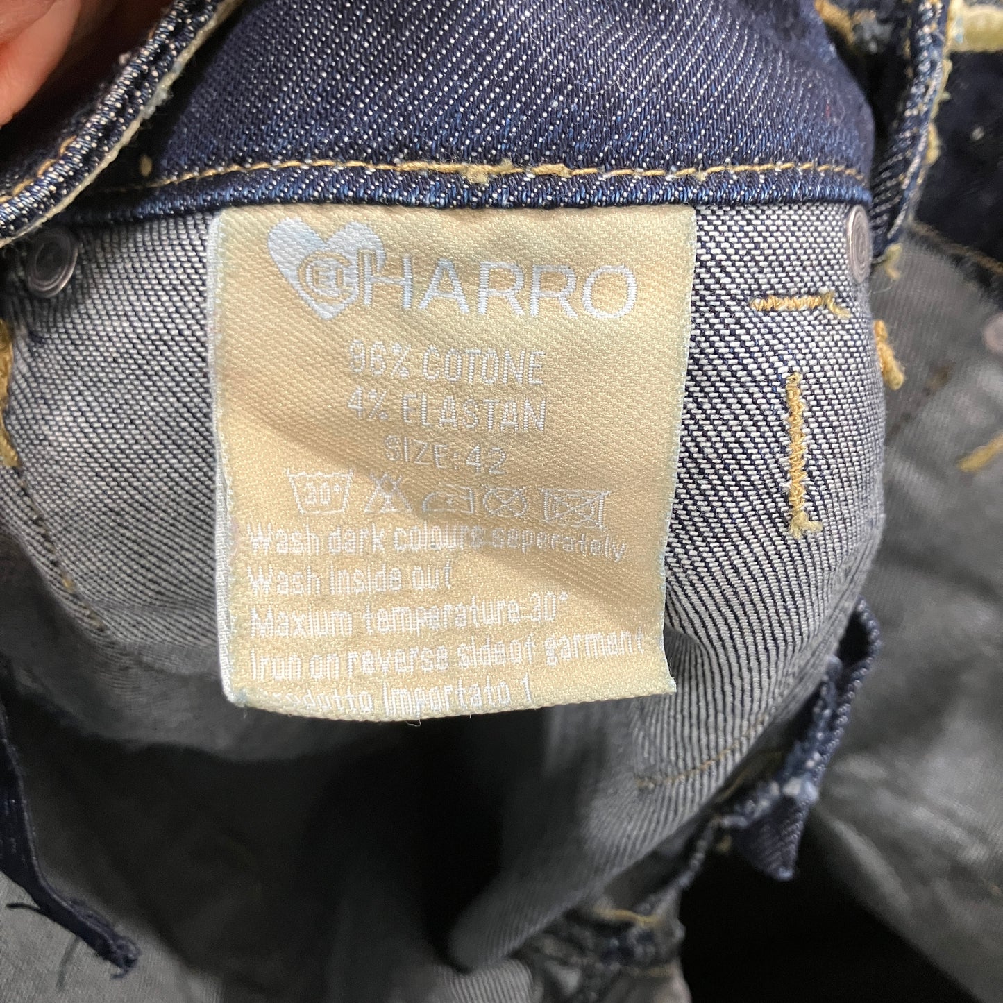 Close-up of a 'CHARRO' label on denim fabric