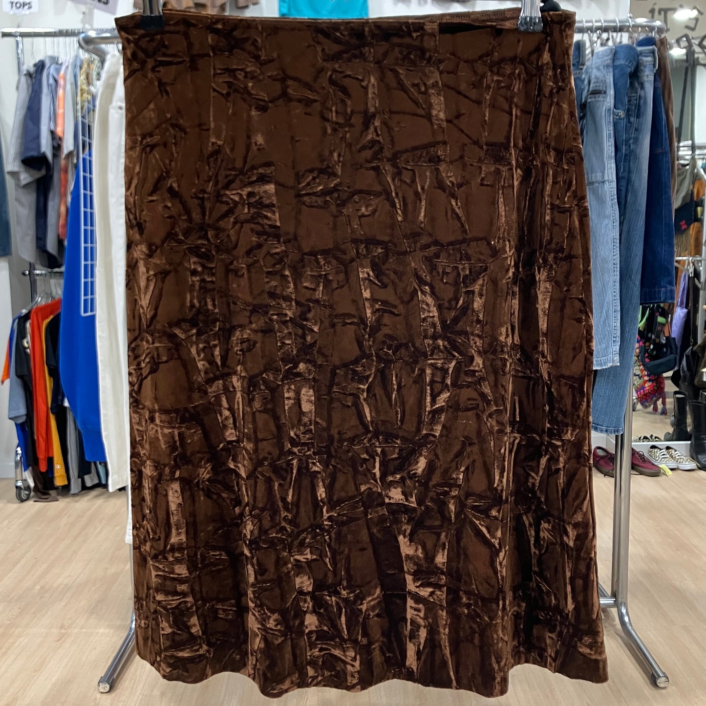 Brown textured skirt on a rack in a store setting