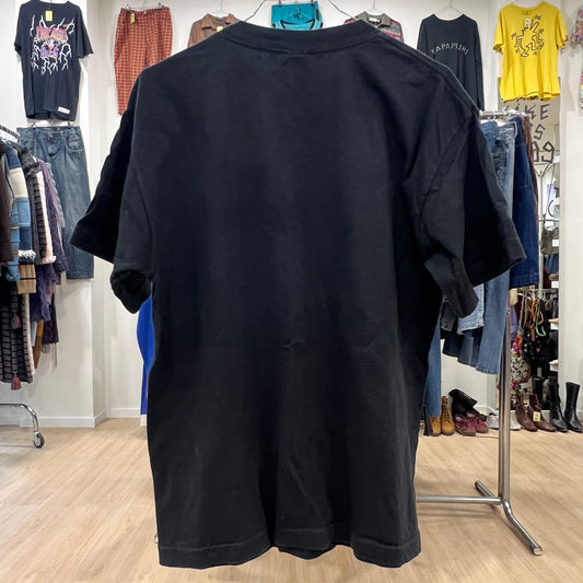 Black t-shirt on a hanger with a clothing store background