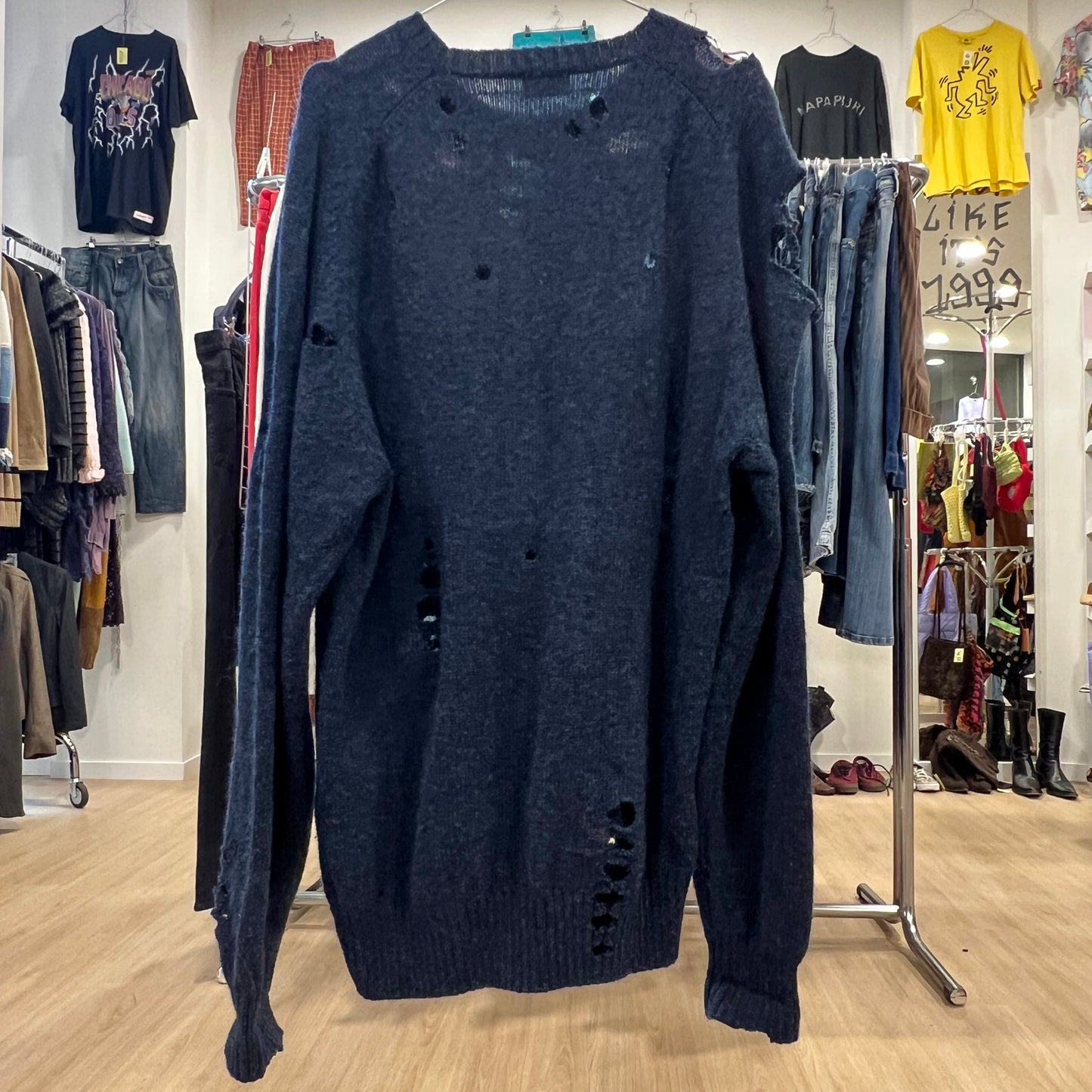 Blue sweater on a wooden floor in a clothing store