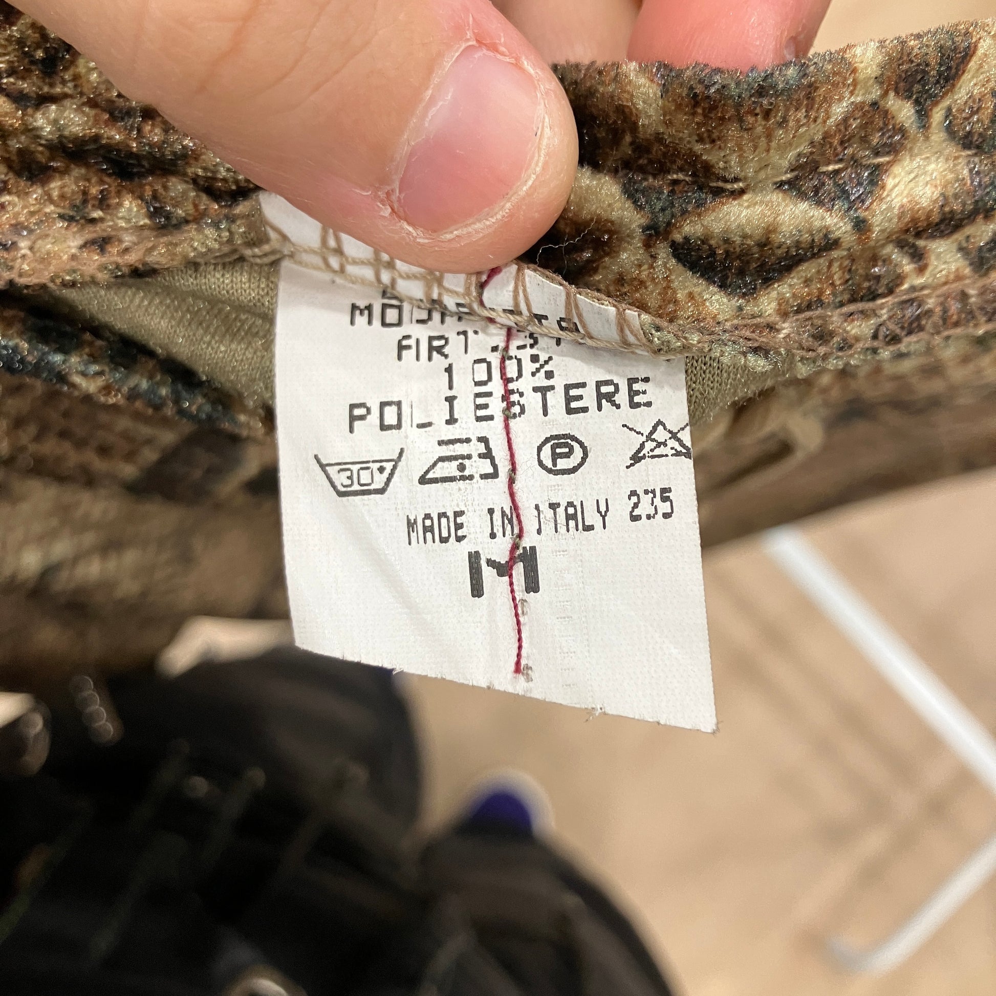 Close-up of a label on a piece of fabric with text and symbols