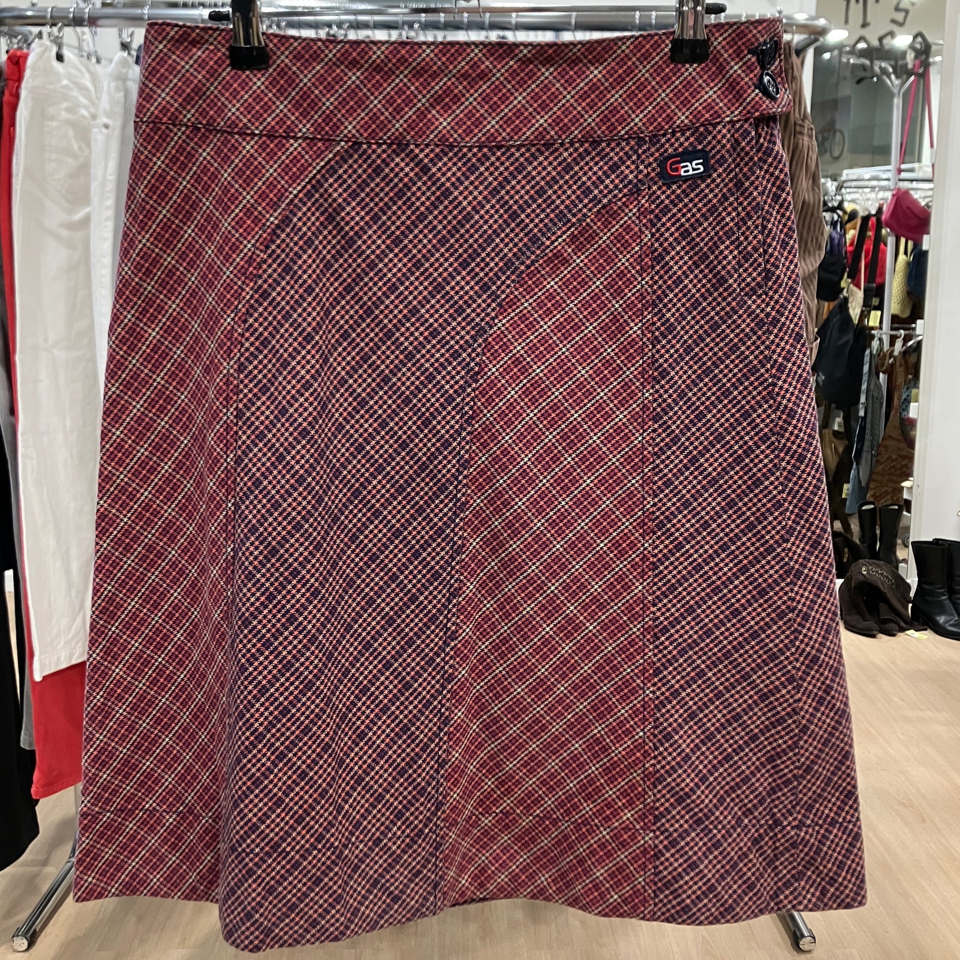 Plaid skirt on a hanger in a store setting