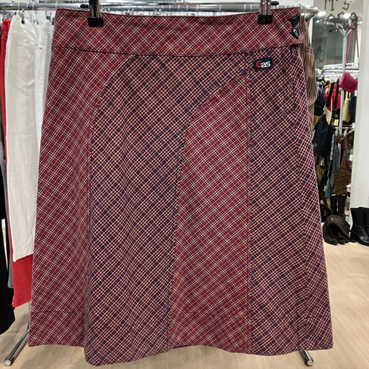 Plaid skirt on a hanger in a store setting