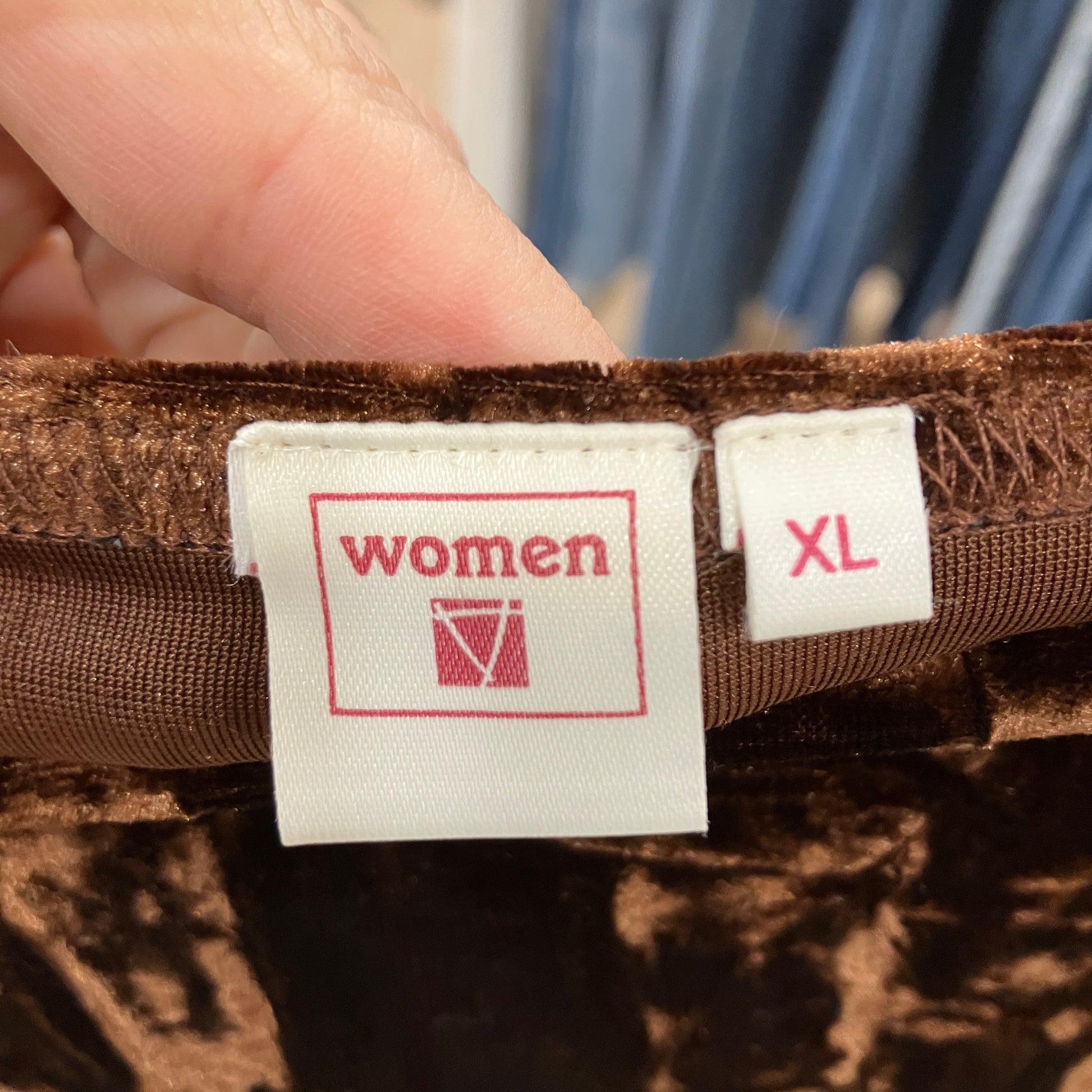 Close-up of a brown fabric with a 'women XL' label