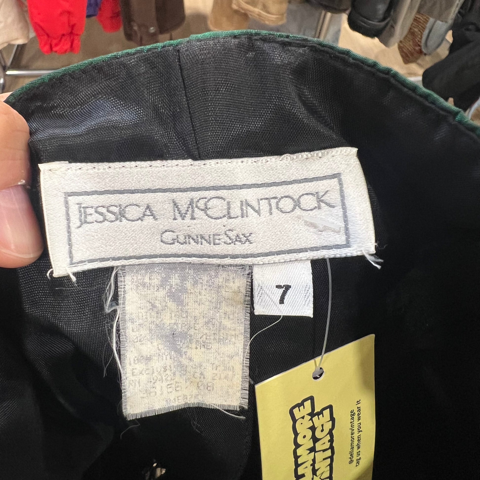 Close-up of a label on a garment with 'Jessica McClintock Gunne Sax' branding