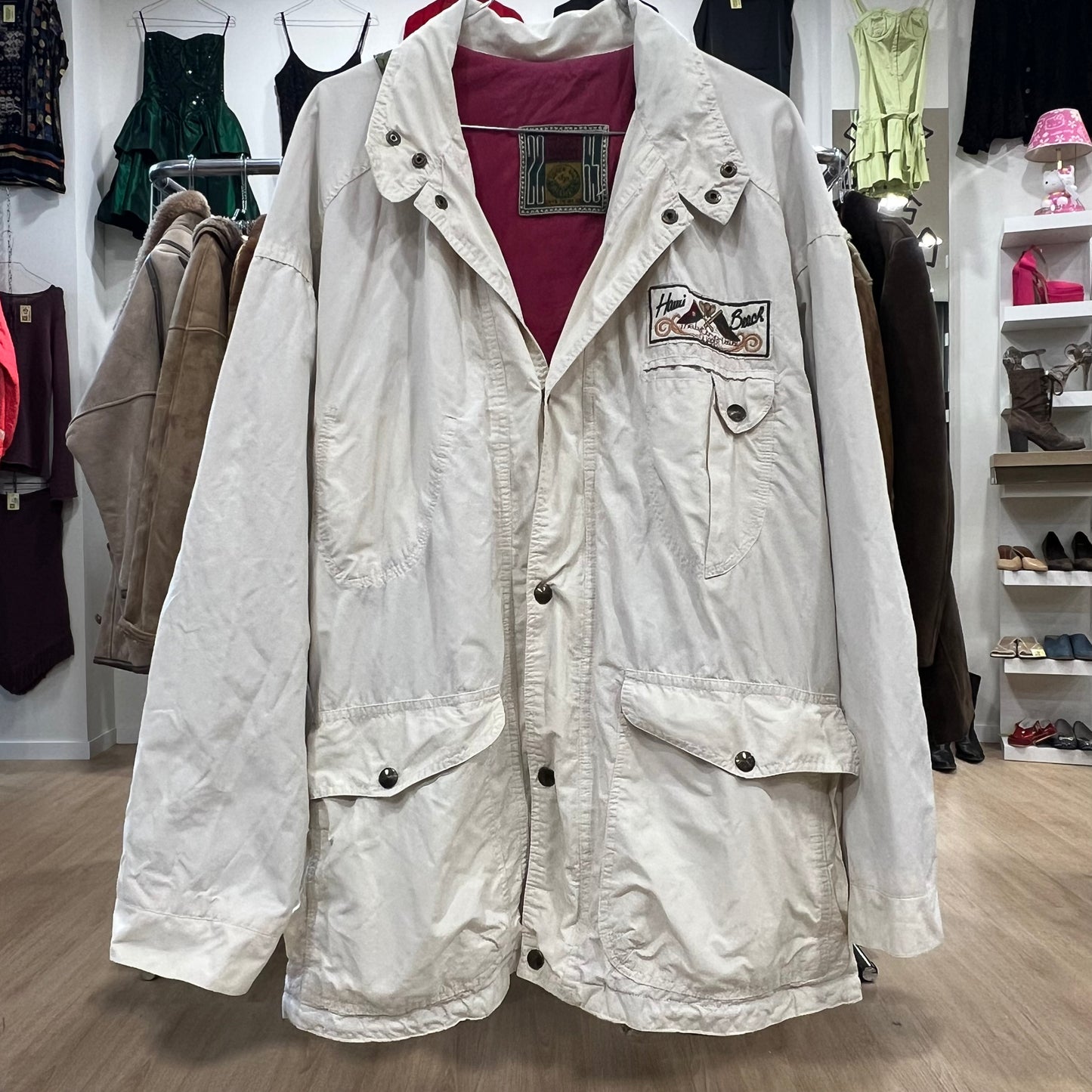 White jacket with a patch on a hanger in a store setting