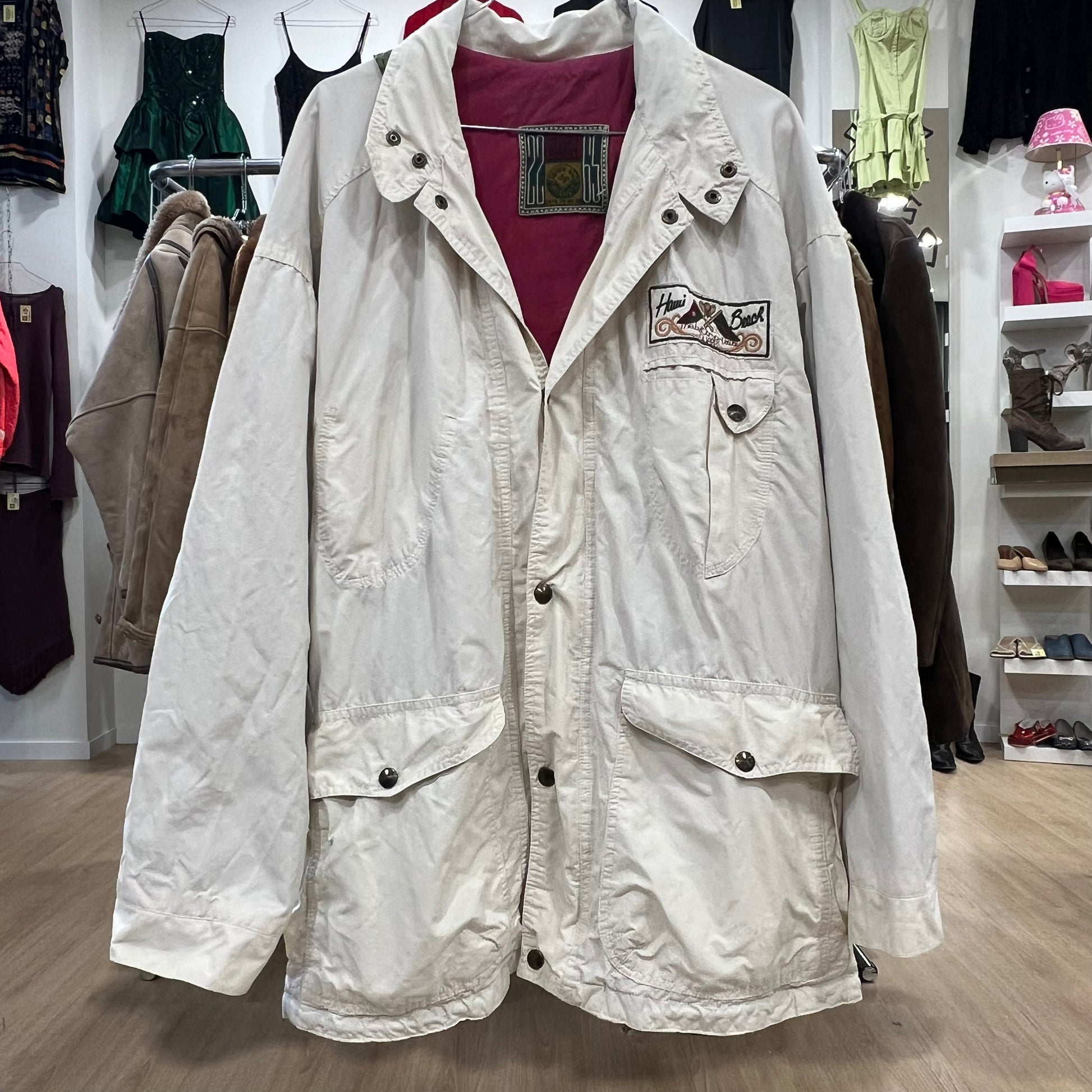 White jacket with a patch on a hanger in a store setting
